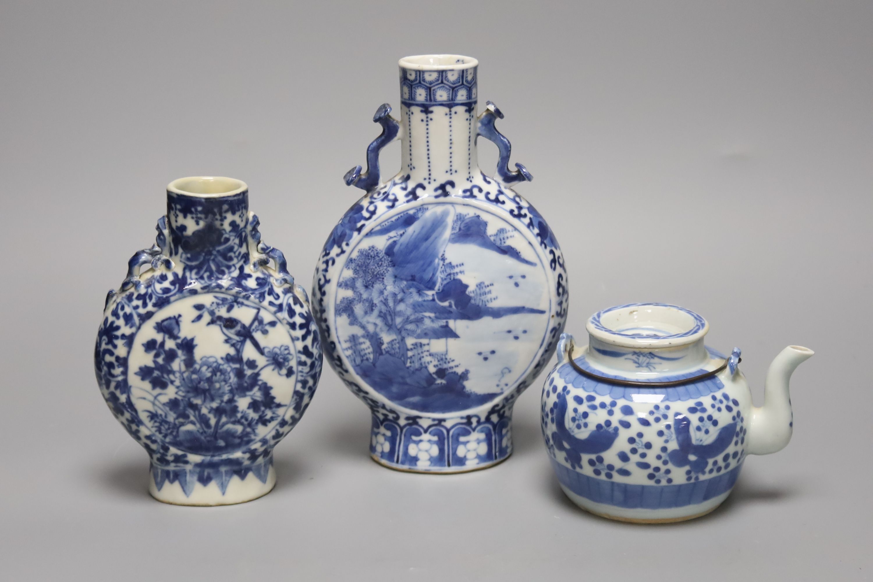 Two 19th century Chinese blue and white moon flasks and a teapot, tallest 21cm